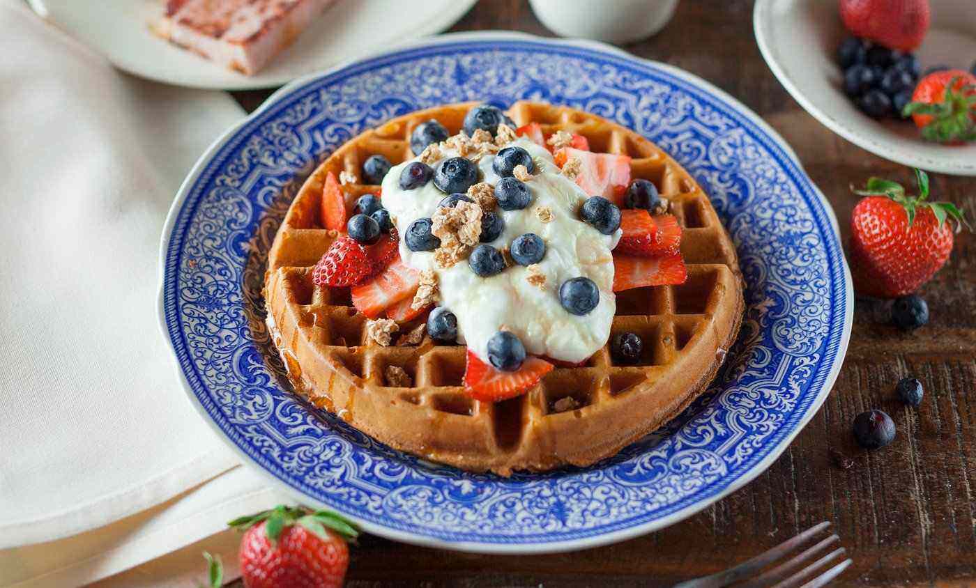 Traditional belgian waffles with berries and cream